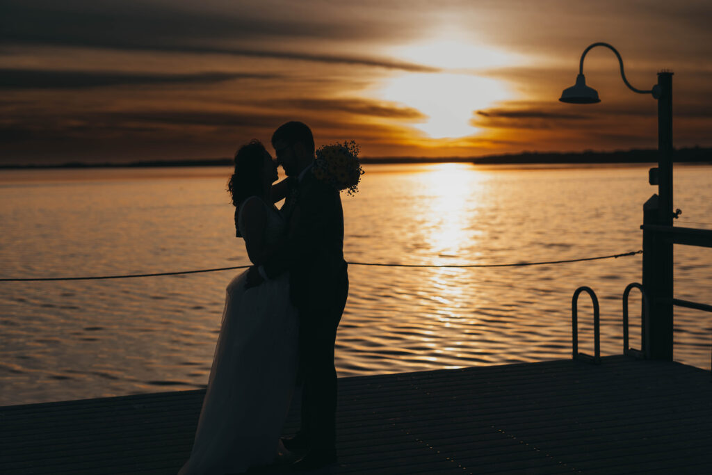 Bride and Groom embracing each other by the ocean at Wedding Venue Tampa Bay Watch for her wedding day in Tampa, Florida