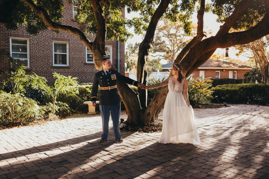 Groom seeing his bride during a first look while standing by a tree in St Petersburg, Florida